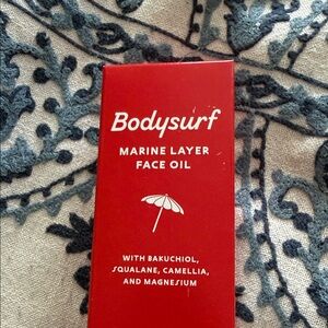 Marine Layer Bodysurf Face Oil in Red Packaging
